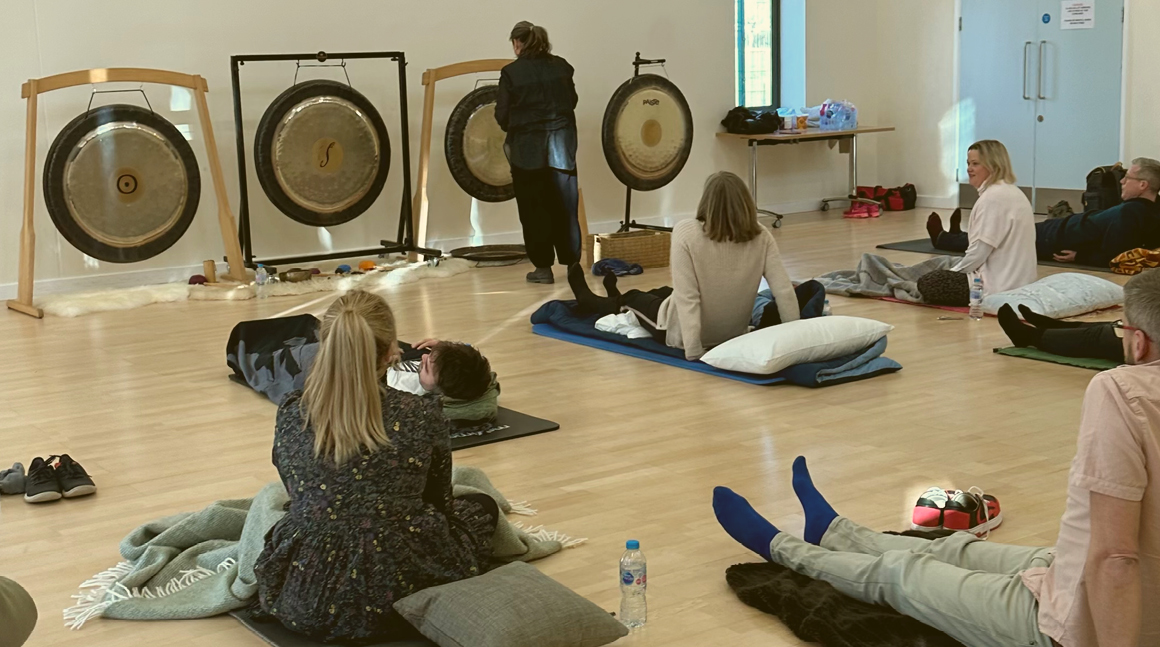 Photograph of some of the mark-making* team preparing to start the sound bath