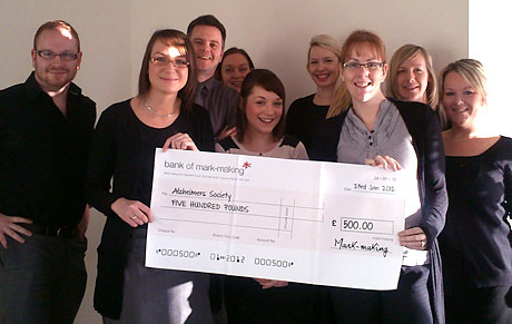 The Nationwide team holding a big cheque